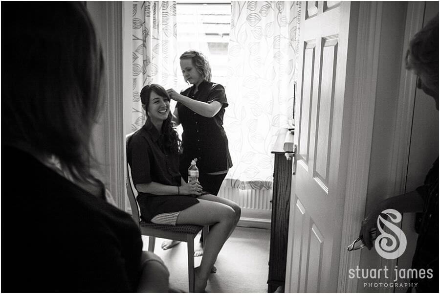 Capturing the bride getting hair and makeup prepared ahead of wedding at The Barns in Cannock by Reportage Wedding Photographer Stuart James