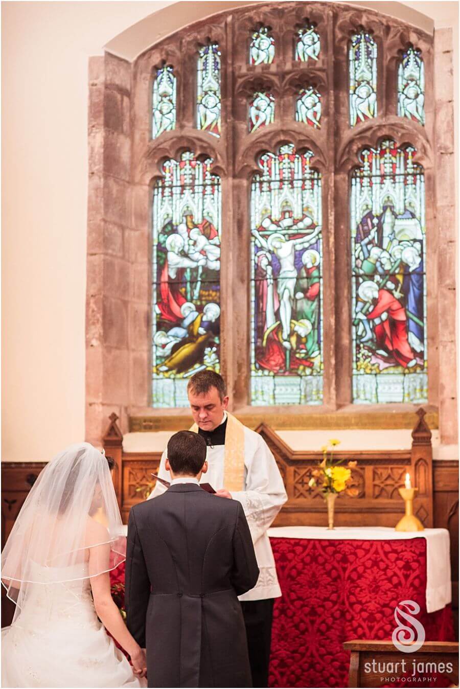 Wedding blessing at Church in grounds of Muncaster Castle in Cumbria captured by Reportage Wedding Photographer Stuart James