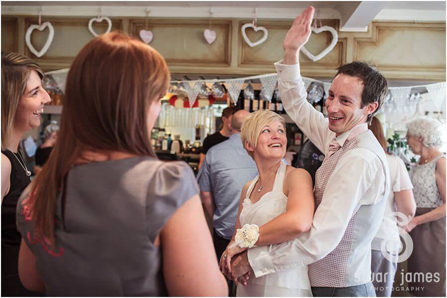 Reportage photographs of guests enjoying wedding reception at The Boat House, Sutton Park in Sutton Coldfield by Candid Wedding Photographer Stuart James