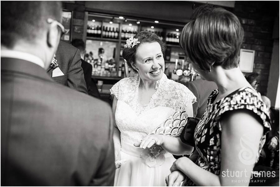 Capturing reportage photographs of guests during drinks reception at The Moat House in Acton Trussell by Venue Preferred Wedding Photographer Stuart James