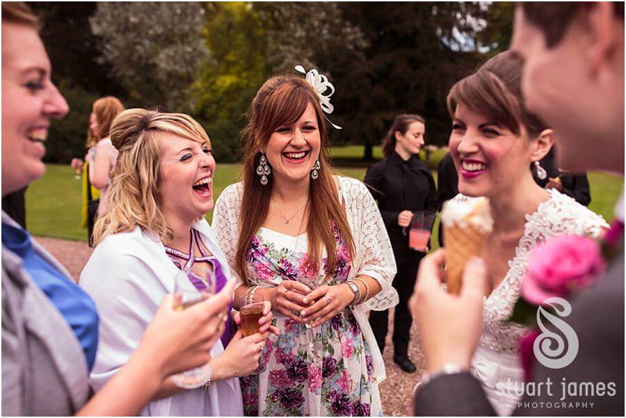 Candid photographs of guests enjoying the drinks reception at Sandon Hall near Stafford by Stafford Wedding Photographer Stuart James