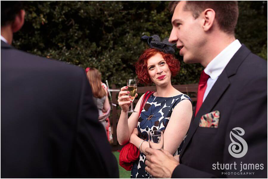 Candid photographs of the guests enjoying the drinks reception at Bride's parents home near Bromsgrove by Reportage Worcester Wedding Photographer Stuart James