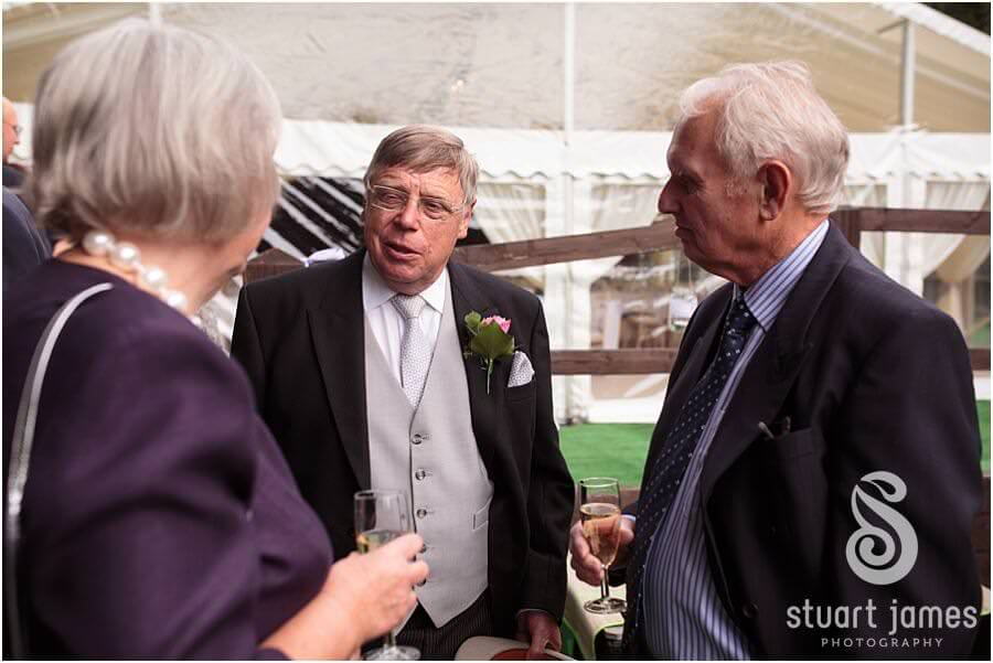 Relaxed wedding photographs of the guests enjoying the drinks reception at Bride's parents home near Bromsgrove by Reportage Worcester Wedding Photographer Stuart James