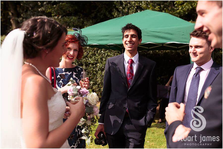 Guests enjoying the stunning September sun in the gardens of Bride's parents home near Chaddesley Corbet by Reportage Bromsgrove Wedding Photographer Stuart James