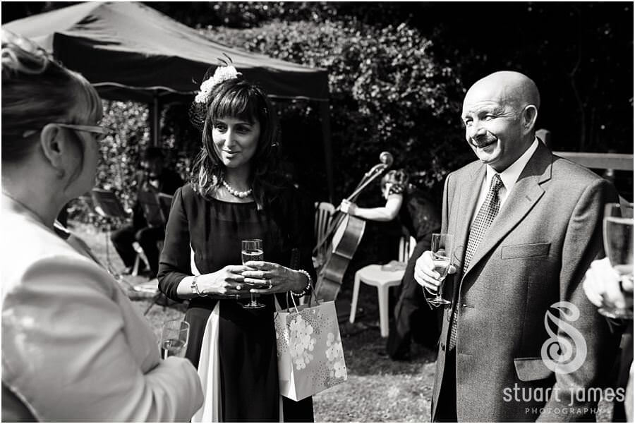 Creative documentary photographs of guests at wedding reception at Bride's parents home near Chaddesley Corbet by Reportage Wedding Photographer Stuart James