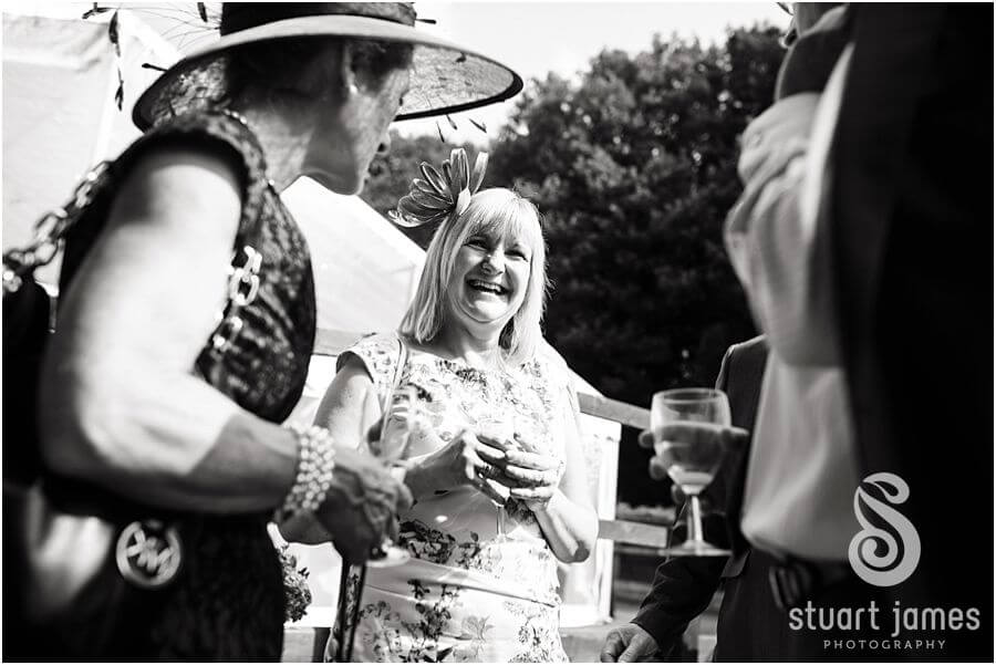 Wedding photographs that show your guests enjoying the wedding reception at Bride's parents home near Chaddesley Corbet by Reportage Wedding Photographer Stuart James
