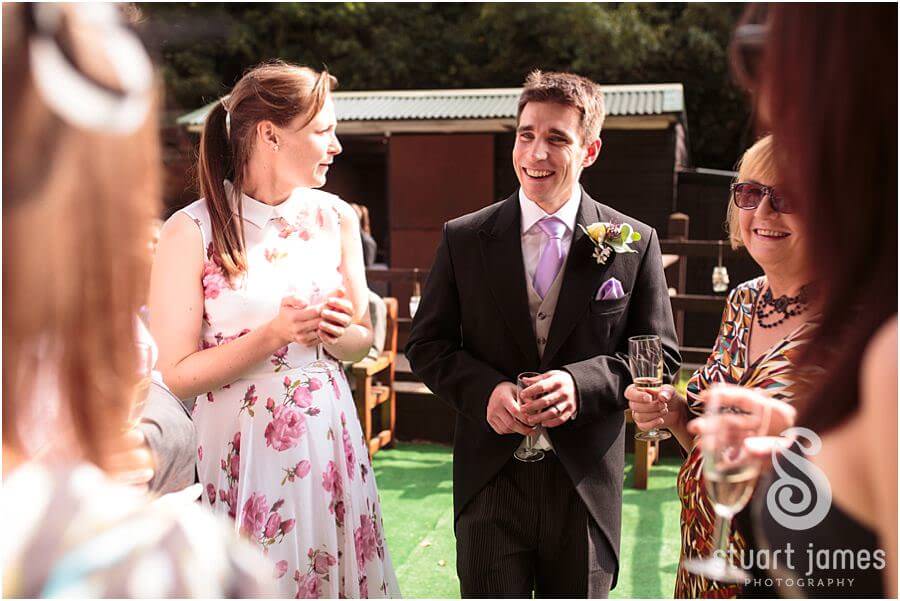 Relaxed wedding photographs of the guests enjoying the drinks reception at Bride's parents home near Bromsgrove by Reportage Worcester Wedding Photographer Stuart James
