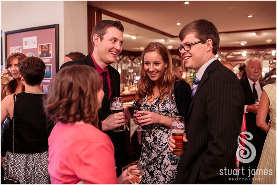 Candid photographs of guests being entertained by close magician at Moor Hall near Sutton Coldfield by Sutton Coldfield Reportage Wedding Photographer Stuart James