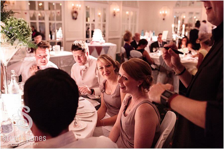 Candid photographs of the guests being entertained during wedding breakfast at Moor Hall near Sutton Coldfield by Sutton Coldfield Reportage Wedding Photographer Stuart James