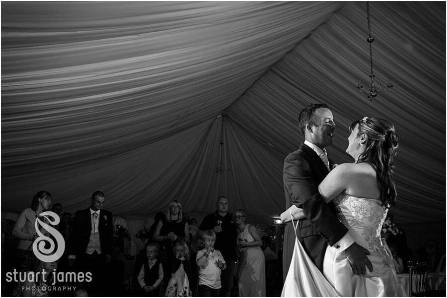 Creative reportage photographs of the first dance in the marquee at Wroxhall Hall in Warwickshire by Warwickshire Documentary Wedding Photographer Stuart James