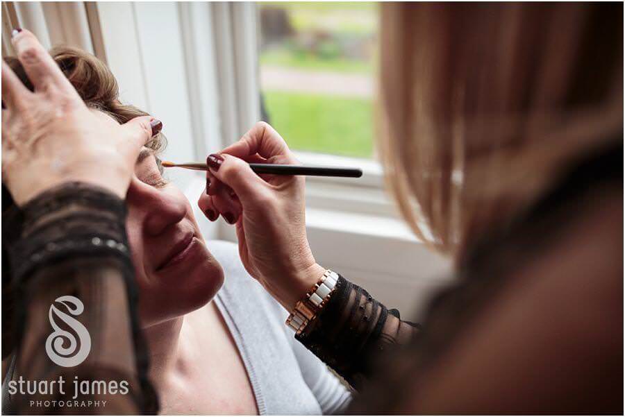 Candid photos of bridal makeup and preparations at Sandon Hall in Stafford by Documentary Wedding Photographer Stuart James