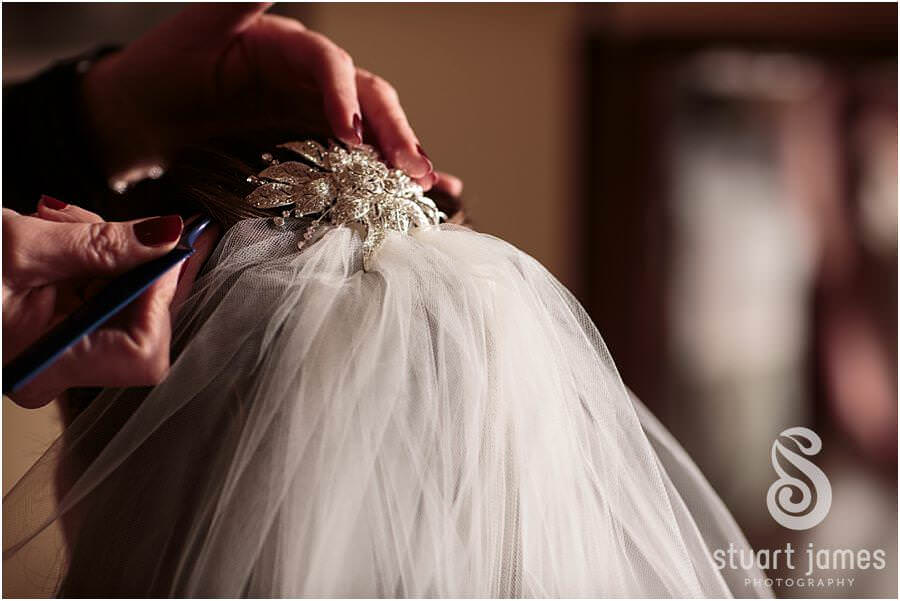 Reportage photos of the bride getting ready with her bridesmaids in the bedroom at Sandon Hall in Stafford by Documentary Wedding Photographer Stuart James