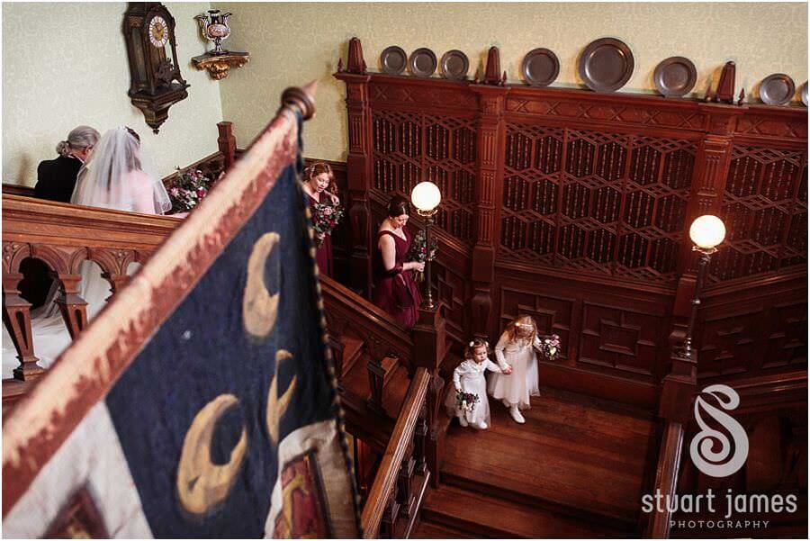 Capturing the bridal party procession down grand staircase at Sandon Hall in Stafford by Documentary Wedding Photographer Stuart James