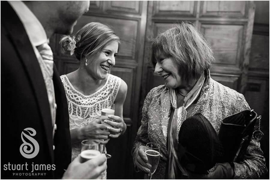 Candid photographs that show the emotion and excitement of the wedding guests greeting the newly married couple in the Gate House at Edinburgh Castle in Edinburgh by Edinburgh Documentary Wedding Photographer Stuart James