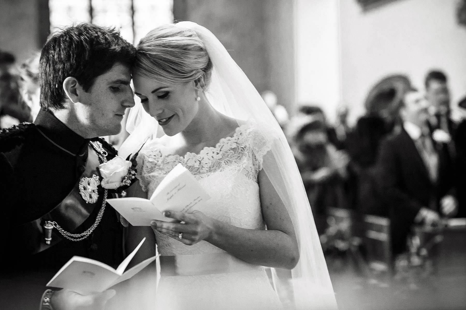 Candid capture of an intimate moment between Bride and Groom during ceremony at Sandon Hall in Stafford by Documentary Wedding Photographer Stuart James