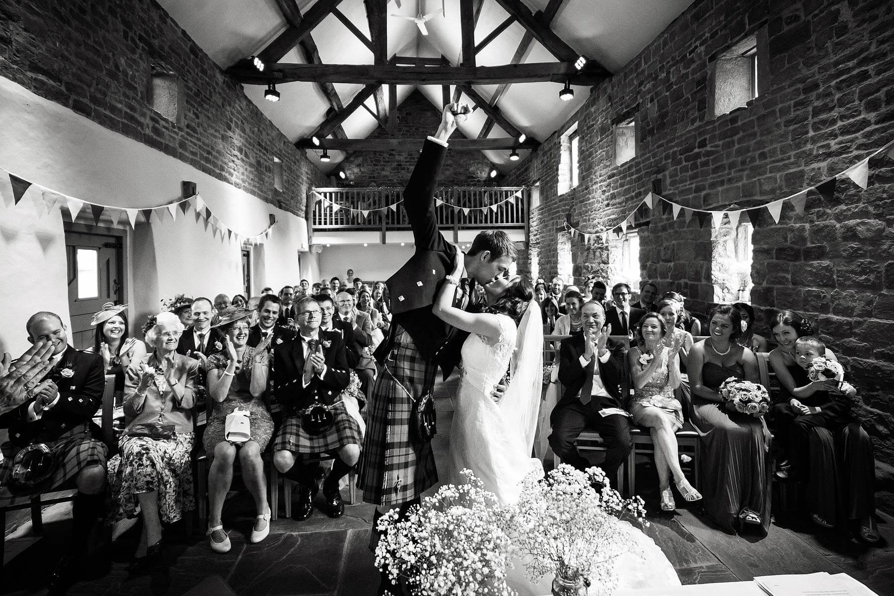 Fabulous reaction to first kiss at The Ashes in Endon by Documentary Wedding Photographer Stuart James
