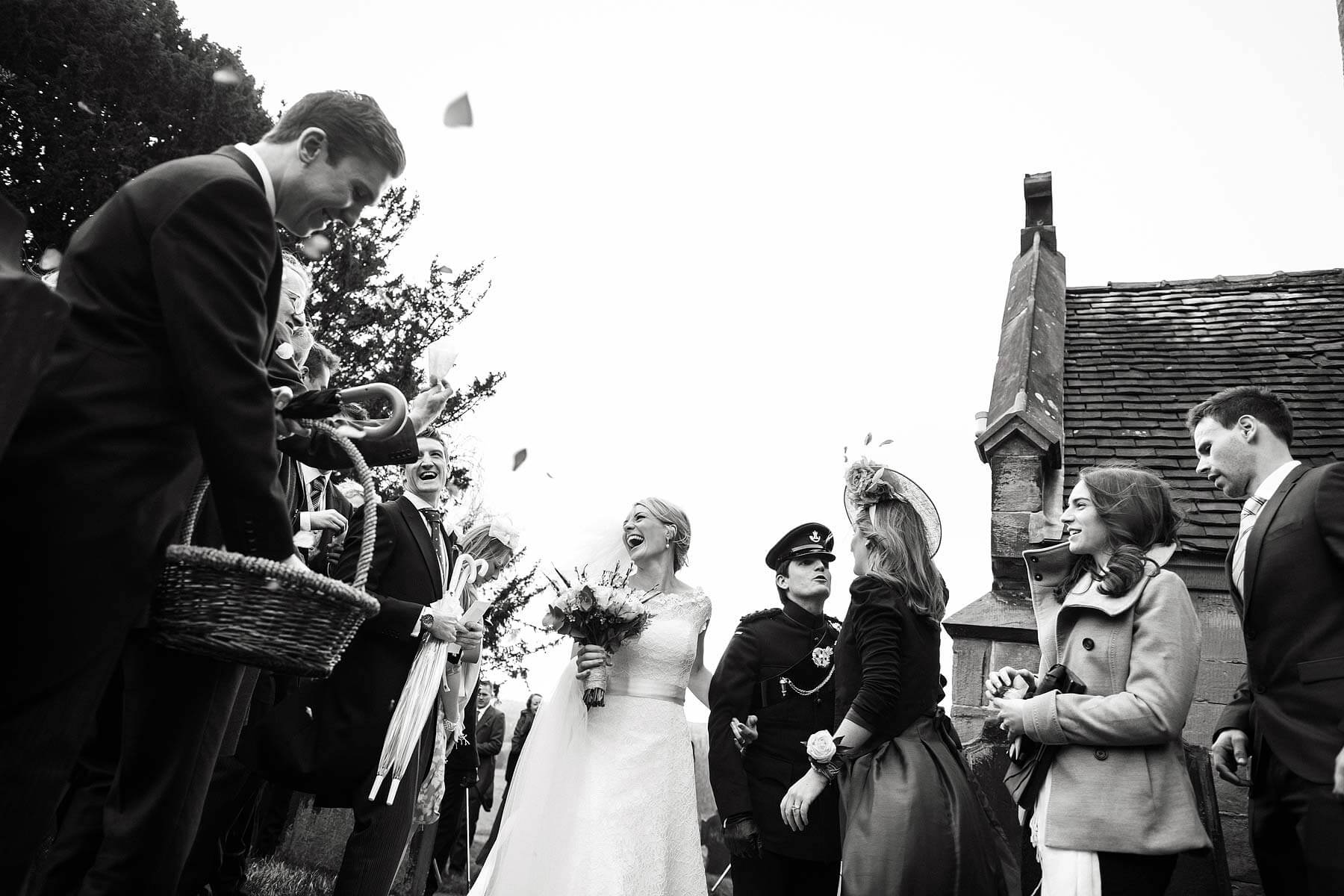 Fabulous emotions and expressions captured in this wonderful reportage photograph as the bride and groom leave the church at Sandon Hall in Stafford by Documentary Wedding Photographer Stuart James