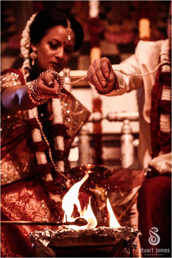Creative storytelling photographs of the Laja Homa capturing the significant meaning of the wedding ceremony at Hare Krishna Temple in Watford by London Documentary Wedding Photographer Stuart James