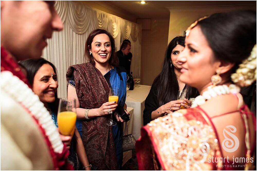 Candid photos of the guests enjoying the wedding reception at the Mercure Hotel in Watford by London Documentary Wedding Photographer Stuart James