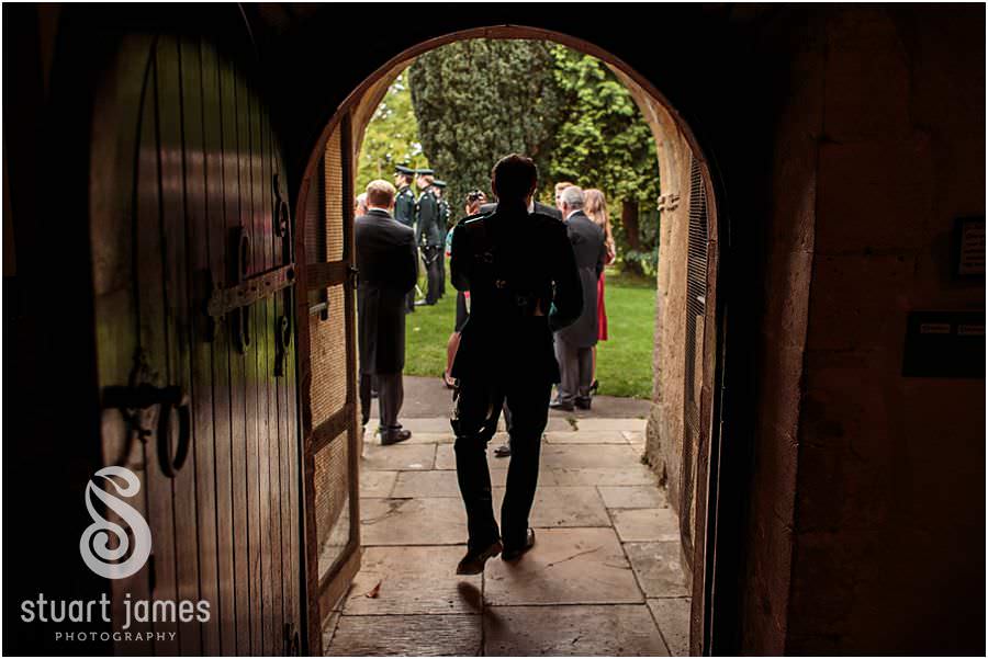 Greeting friends and family as they arrive at St Marys Church in Cogges by Documentary Wedding Photographer Stuart James