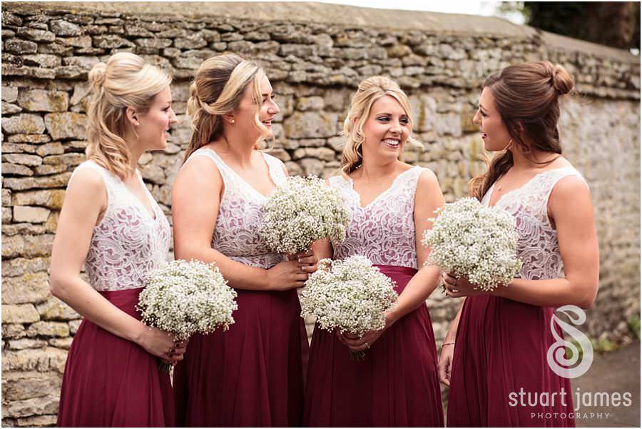 Excitement on the faces of the guests as they arrive for the wedding at St Marys Church in Cogges by Documentary Wedding Photographer Stuart James