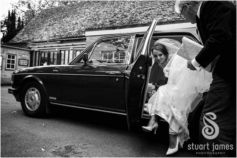 Greeting friends and family as they arrive at St Marys Church in Cogges by Documentary Wedding Photographer Stuart James