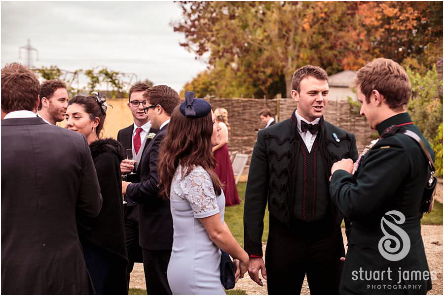 Candid photos of the drinks reception at Oxleaze Barn in Gloucestershire by Documentary Wedding Photographer Stuart James