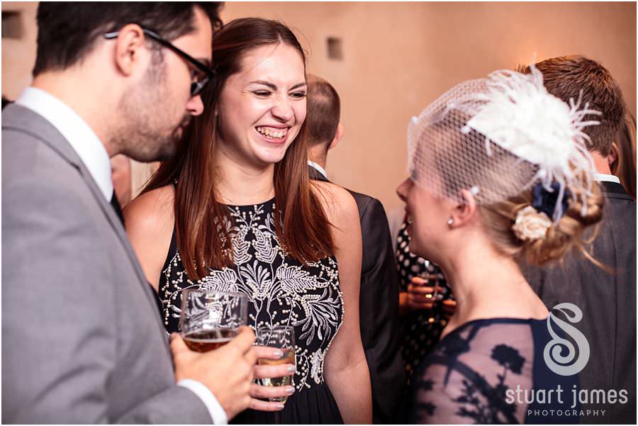 Capturing the fun of the wedding reception with creative candid photographs at Oxleaze Barn in Gloucestershire by Documentary Wedding Photographer Stuart James