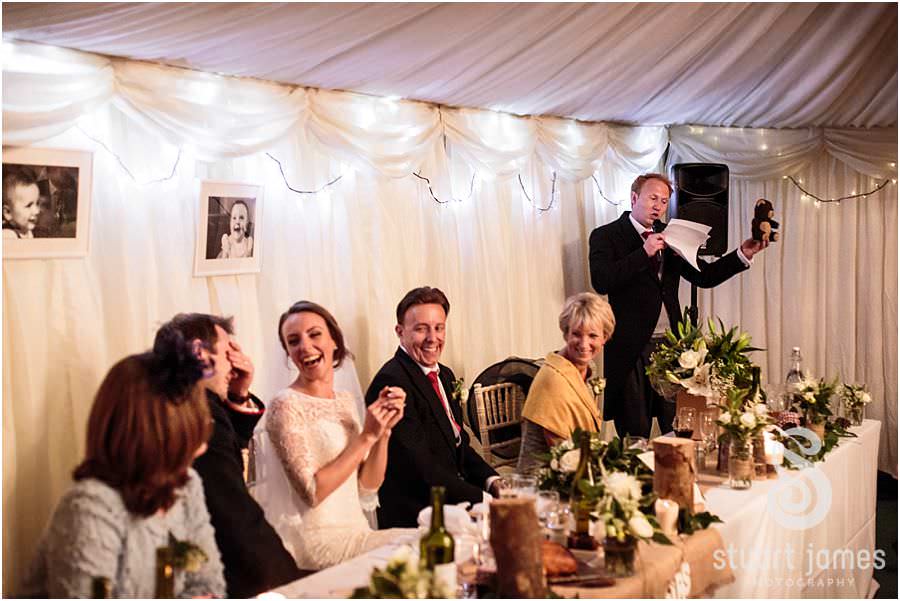 Bringing the reaction to the Best Mans speech alive in photos at Oxleaze Barn in Gloucestershire by Documentary Wedding Photographer Stuart James
