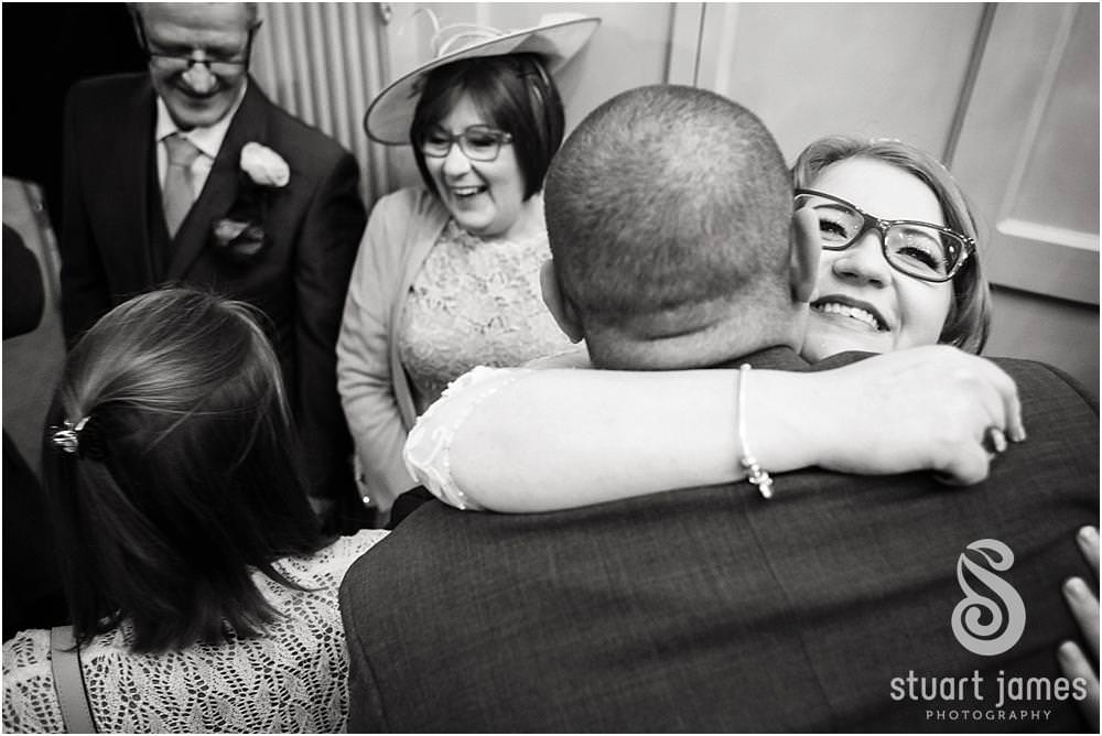 Candid photographs as guests enjoy the beautiful wedding at Weston Hall in Stafford by Documentary Wedding Photographer Stuart James