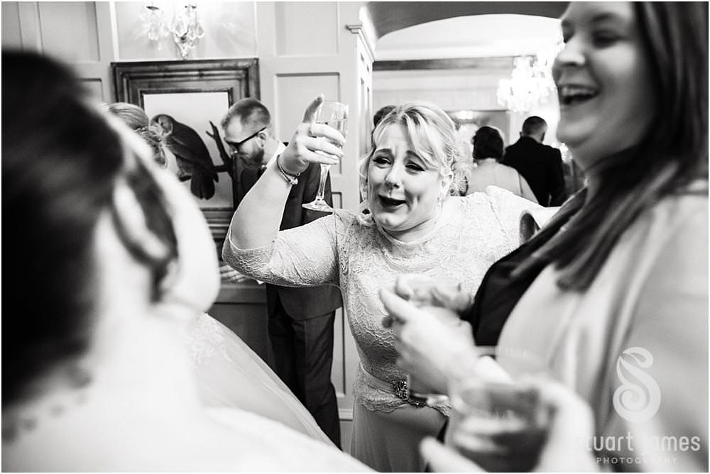 Candid photos as the guests enjoy the wedding reception at Weston Hall in Stafford by Documentary Wedding Photographer Stuart James