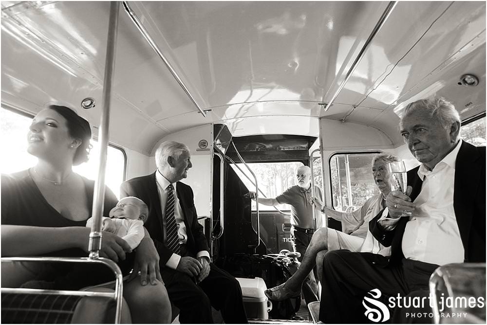 Capturing the guests enjoying the tour of London on the bus for the reception at Chelsea Harbour Hotel in Chelsea by Chelsea Registry Office Wedding Photographer Stuart James