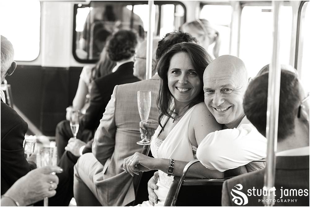 Capturing the guests enjoying the tour of London on the bus for the reception at Chelsea Harbour Hotel in Chelsea by Chelsea Registry Office Wedding Photographer Stuart James