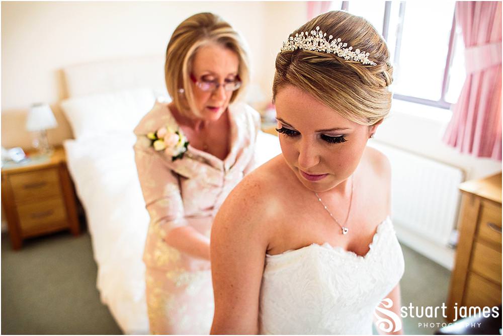One of my favourite moments to capture as the Mother of the Bride helps her daughter in to her wedding gown