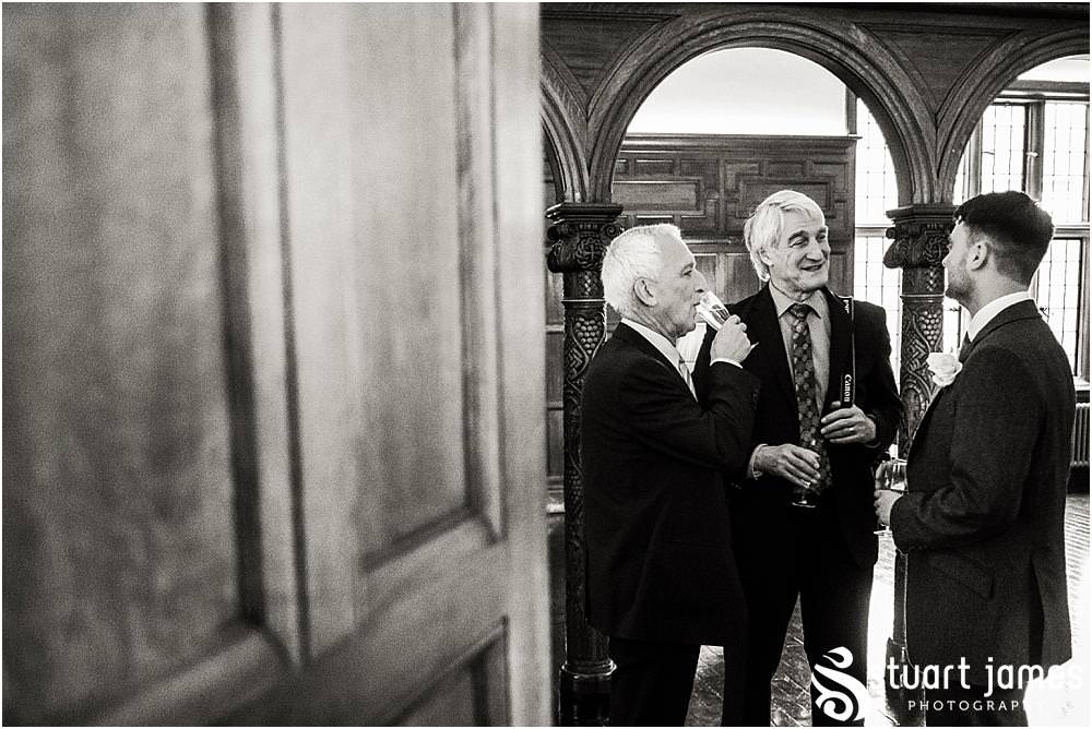 Creative reportage photography of the guests enjoying the drinks reception in the fabulous surroundings of Pendrell Hall in Codsall, Wolverhampton by Pendrell Hall Wedding Photographer Stuart James