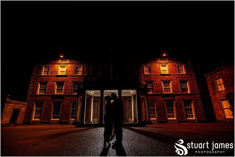 Creative wedding photographs of the Bride and Groom silhouette to the stunning house of Weston Park