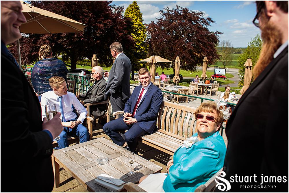 Candid photographs of the guests enjoying the drinks reception on the sun drenched terrace at Weston Hall