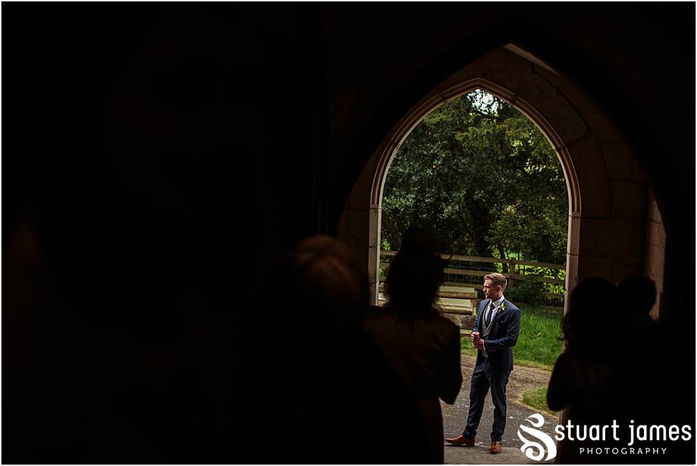Capturing the arrival of the groomsmen and guests for the wedding at All Saints Church in Sandon by Documentary Wedding Photographer Stuart James