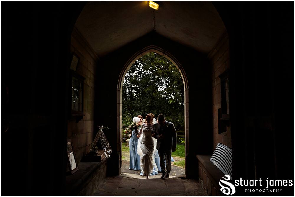 Documenting the arrival of the bridal party at All Saints Church in Sandon by Documentary Wedding Photographer Stuart James
