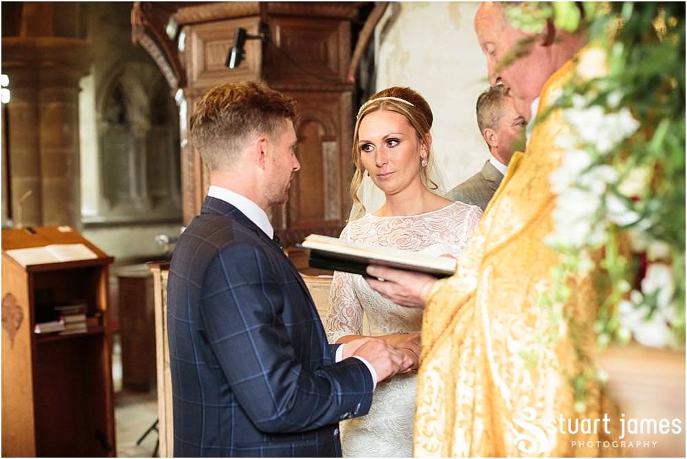 Telling the story of the wedding ceremony with unobtrusive documentary wedding photography at All Saints Church in Sandon by Documentary Wedding Photographer Stuart James