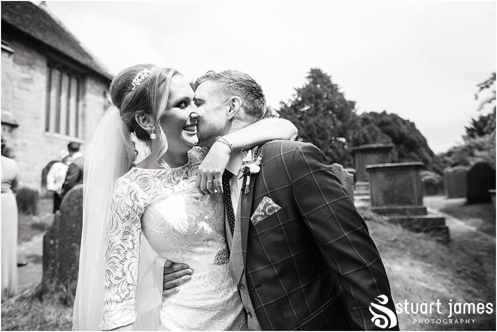 Capturing the wonderful congratulations as the guests greet the newly married couple at All Saints Church in Sandon by Documentary Wedding Photographer Stuart James