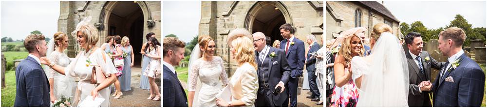 Capturing the wonderful congratulations as the guests greet the newly married couple at All Saints Church in Sandon by Documentary Wedding Photographer Stuart James
