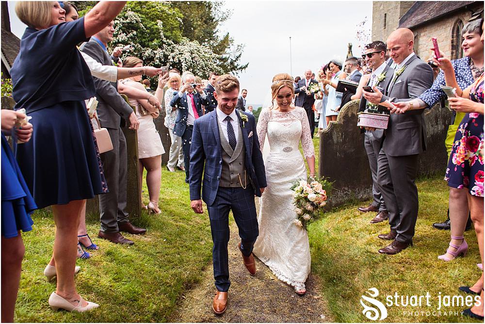 Confetti fun to exit the church at All Saints Church in Sandon by Documentary Wedding Photographer Stuart James