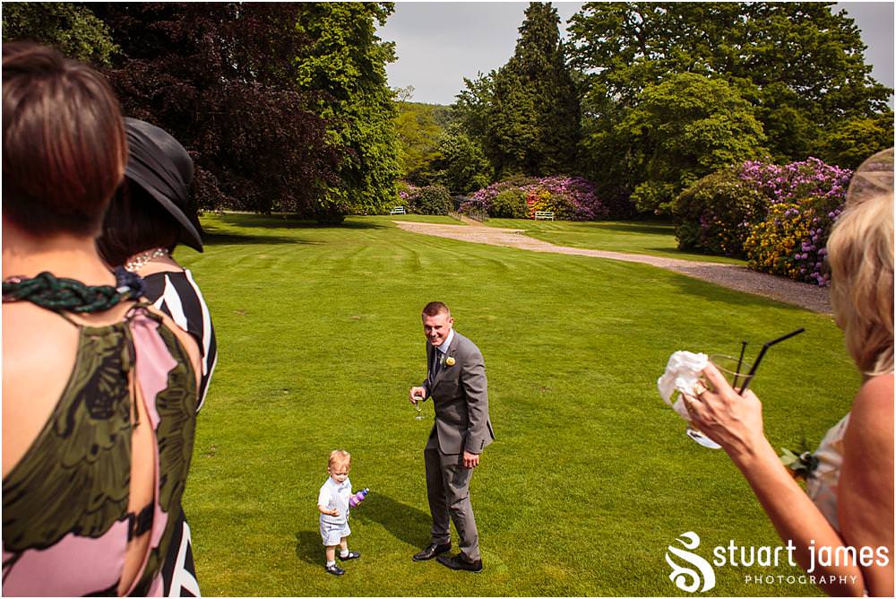 Creative candid photographs of the guests enjoying the drinks reception at Sandon Hall in Stafford by Documentary Wedding Photographer Stuart James