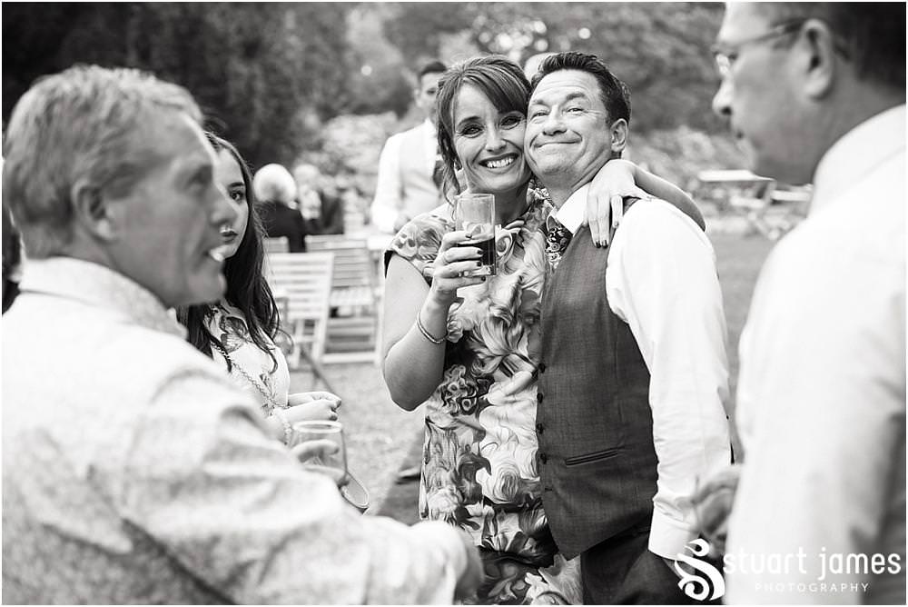 Candid photographs of the guests enjoying the Staffordhire Tipi Wedding reception at Sandon by Documentary Wedding Photographer Stuart James