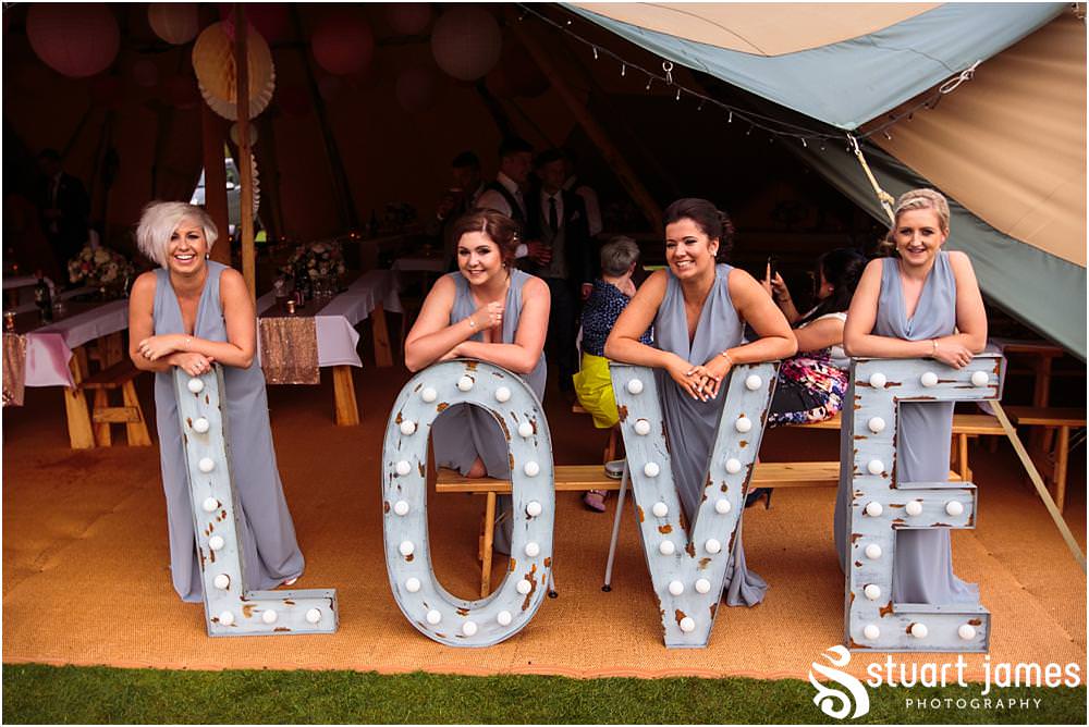 Candid photographs of the guests enjoying the Staffordhire Tipi Wedding reception at Sandon by Documentary Wedding Photographer Stuart James