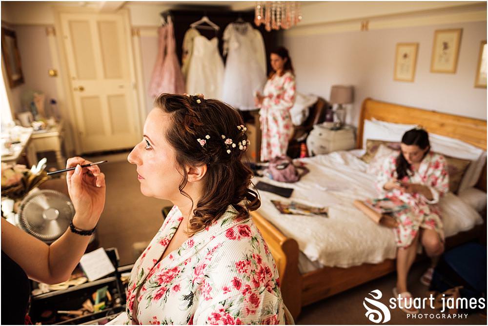 Candid photographs that tell the story of the wedding morning for the finishing touches to the bridal makeup at Netherstowe House in Lichfield by Lichfield Wedding Photographer Stuart James
