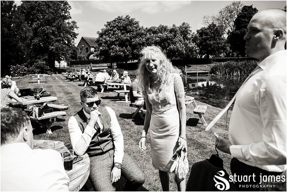 Candid photographs as the groom and groomsmen relax at The Moat House in Acton Trussell by Documentary Wedding Photographer Stuart James
