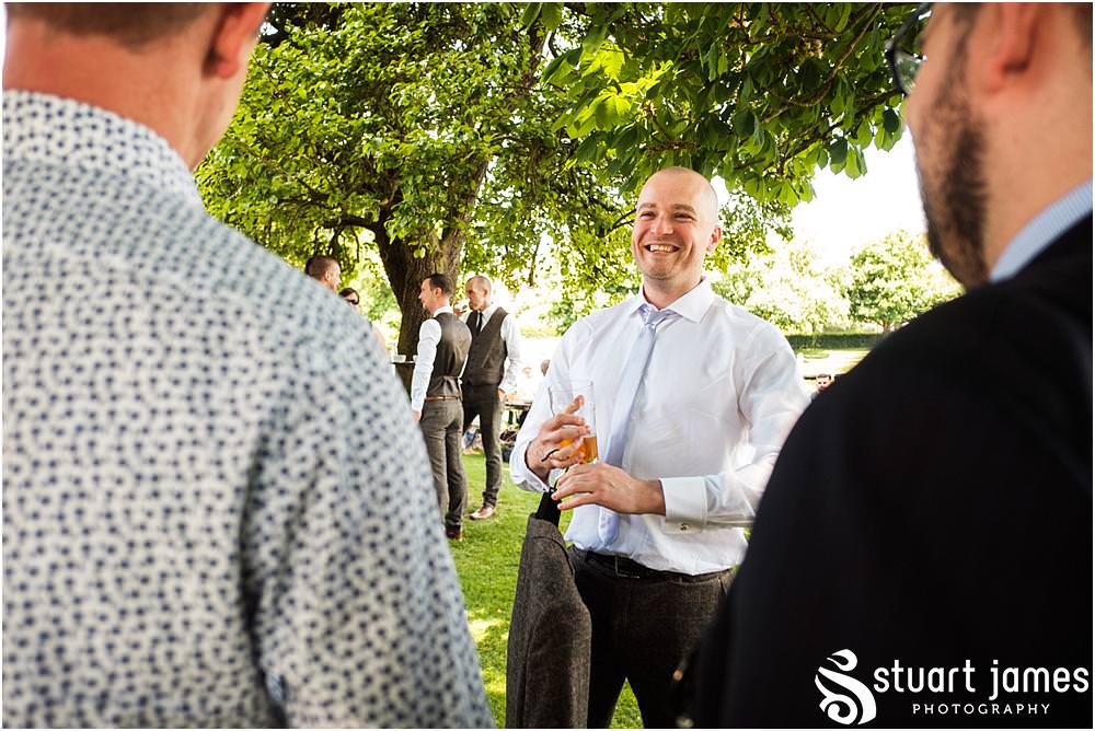 Candid photographs as the groom and groomsmen relax at The Moat House in Acton Trussell by Documentary Wedding Photographer Stuart James