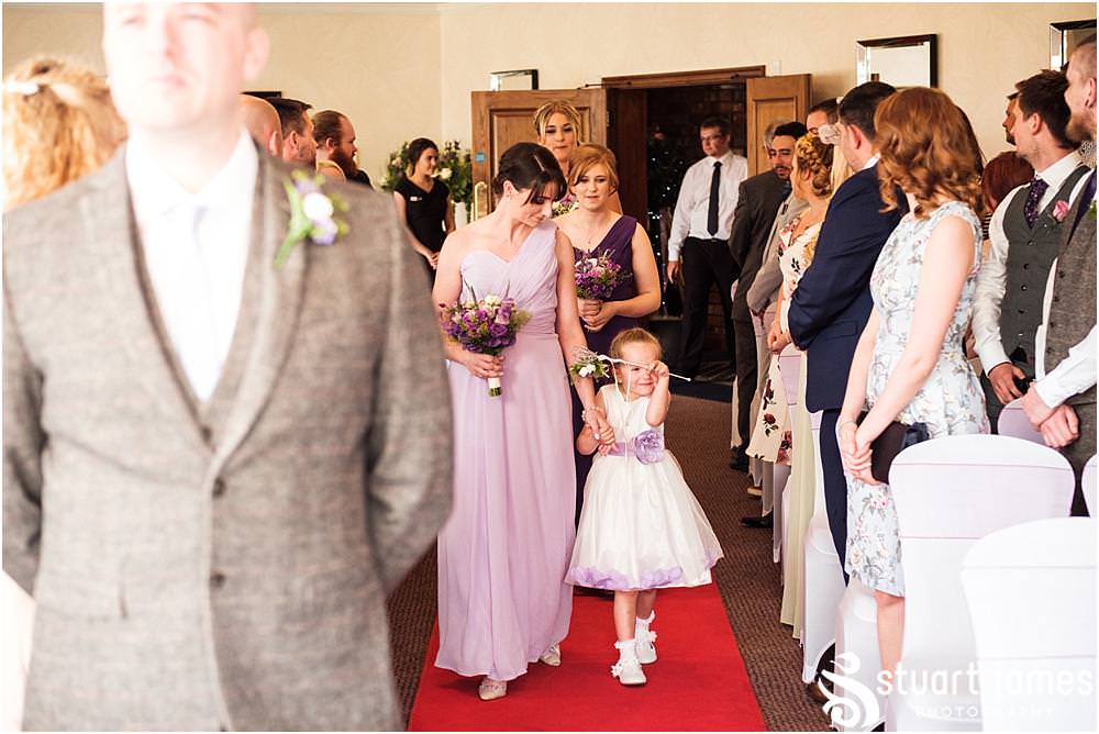 Documenting the entrance to the ceremony of the bridal party, showing the mood and emotion of the beautiful moment at The Moat House in Acton Trussell by Documentary Wedding Photographer Stuart James